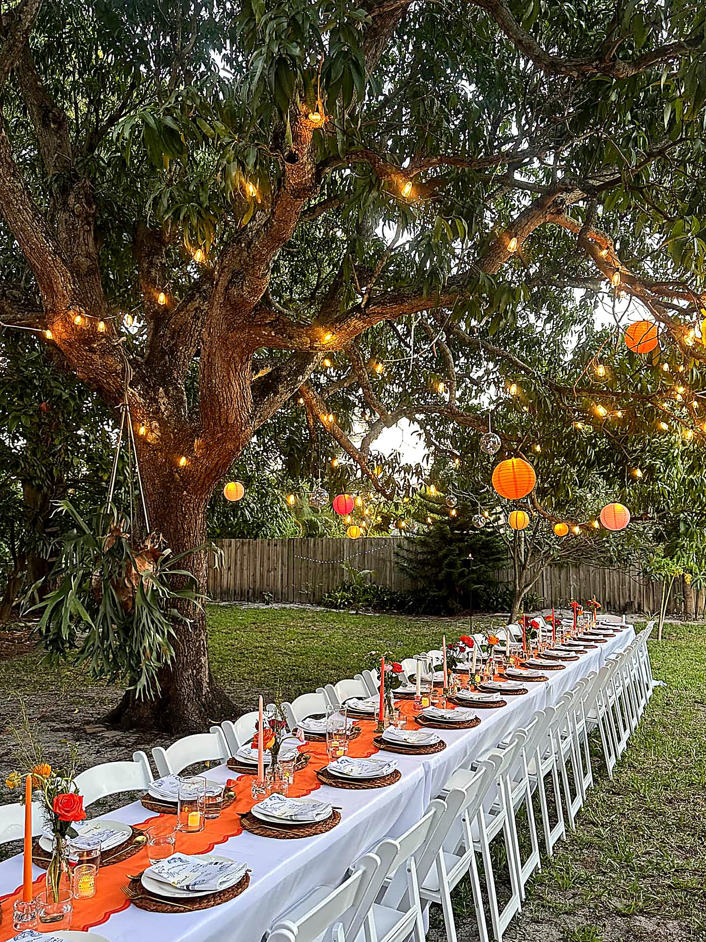 Outdoor dinner setup under string lights