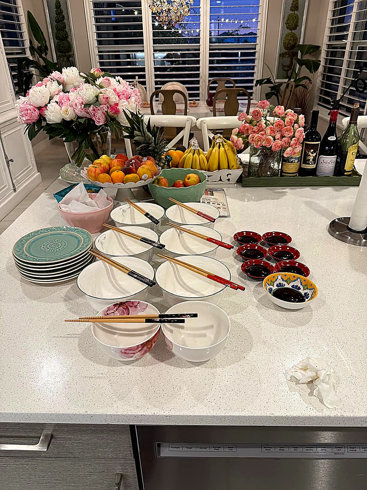 Intimate table dressing — bowls, chopsticks, peonies and roses on a marble counter