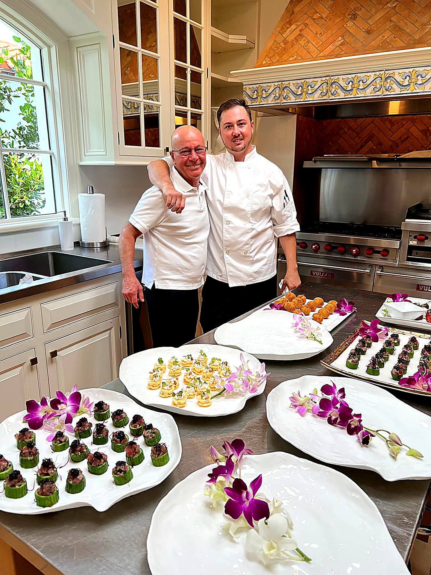 Chef Pablo and his sous chef with a full appetizer spread