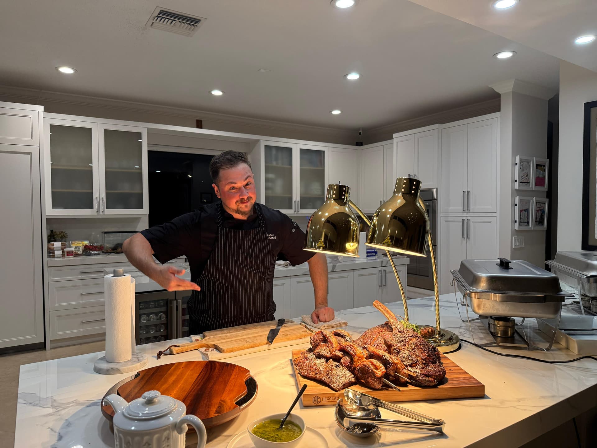 Chef Pablo Sarmiento presenting a roasted prime rib in his kitchen