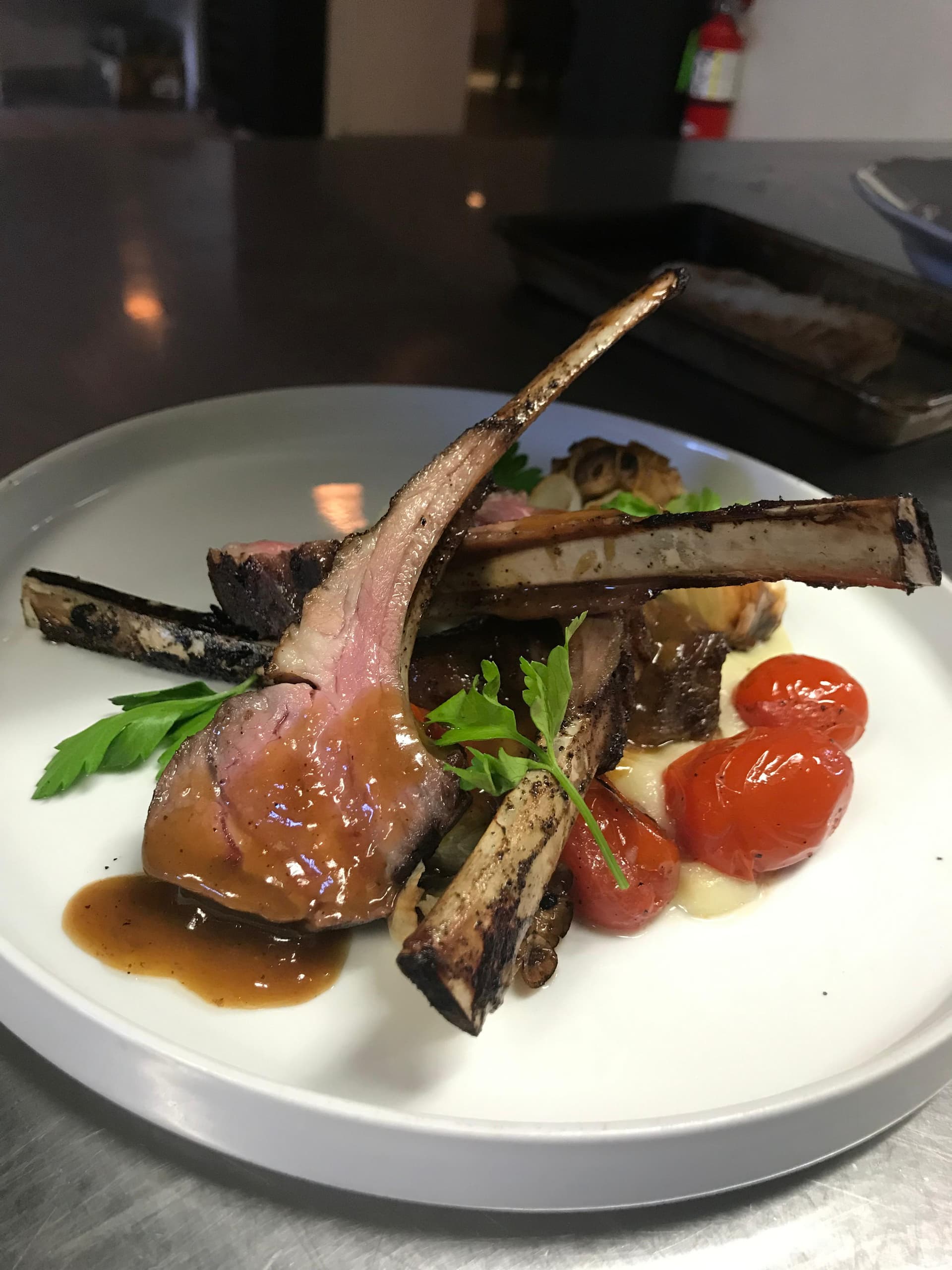 Chef Pablo's signature herb-crusted rack of lamb with roasted heirloom tomatoes and parsley